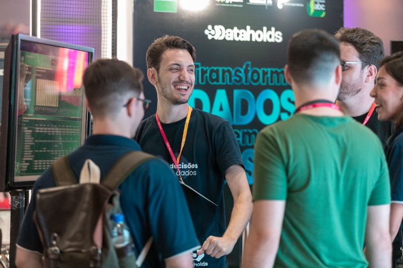 Employees using AI assistants on digital devices in a modern corporate training room