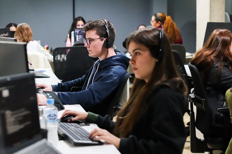 New employees attending an onboarding session with a manager in a modern office