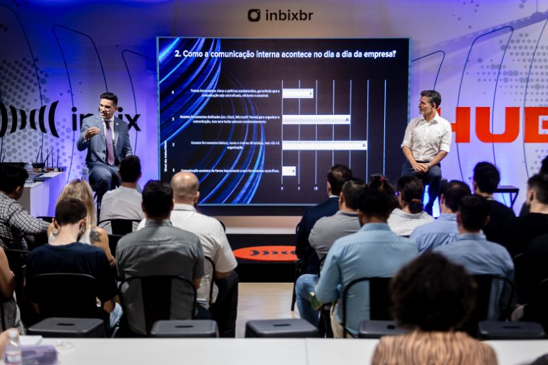 Business professionals analyzing predictive HR data on transparent digital screens in modern office